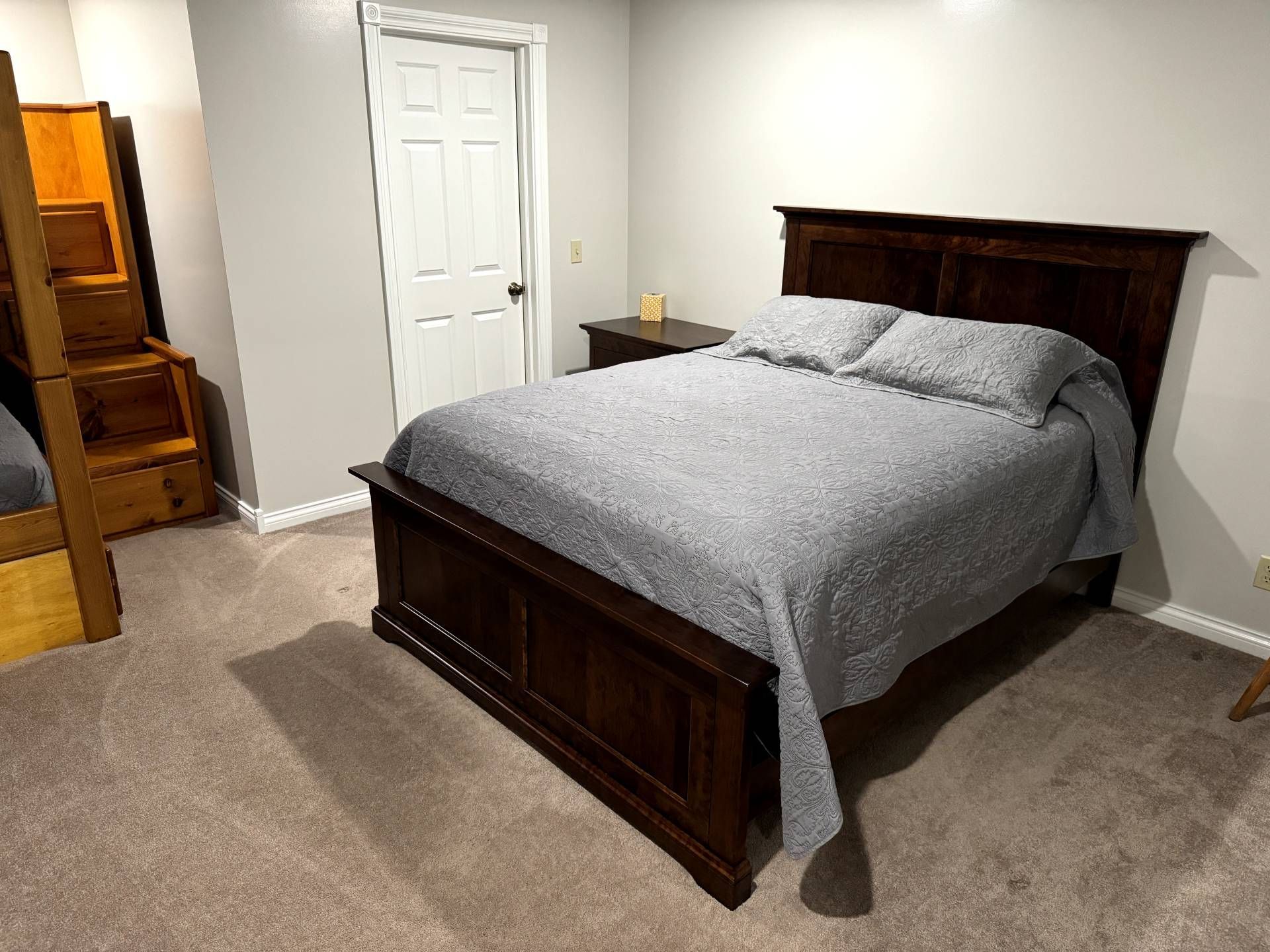 A bedroom with a king size bed and bunk beds.