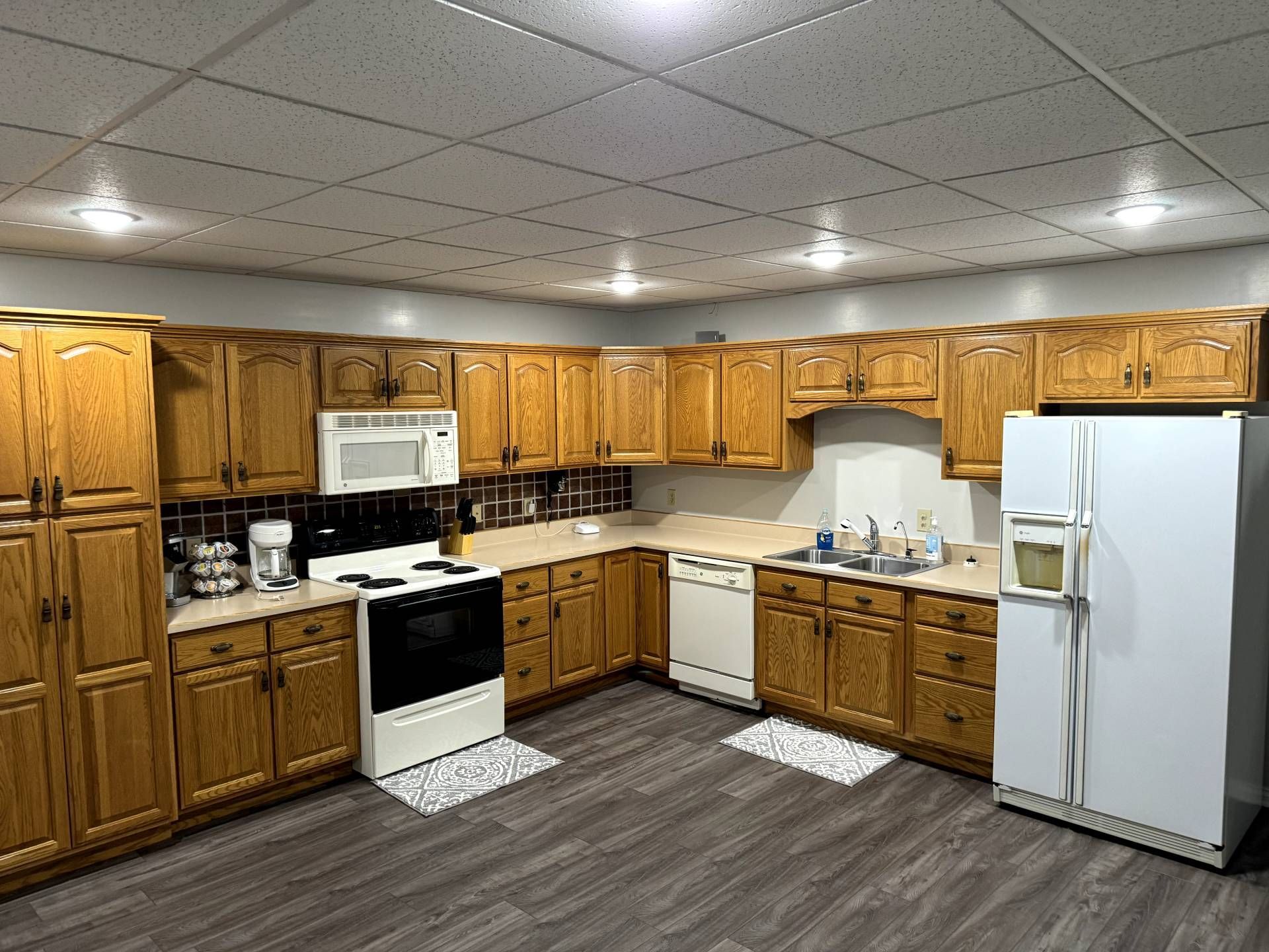 A kitchen with wooden cabinets and a white refrigerator