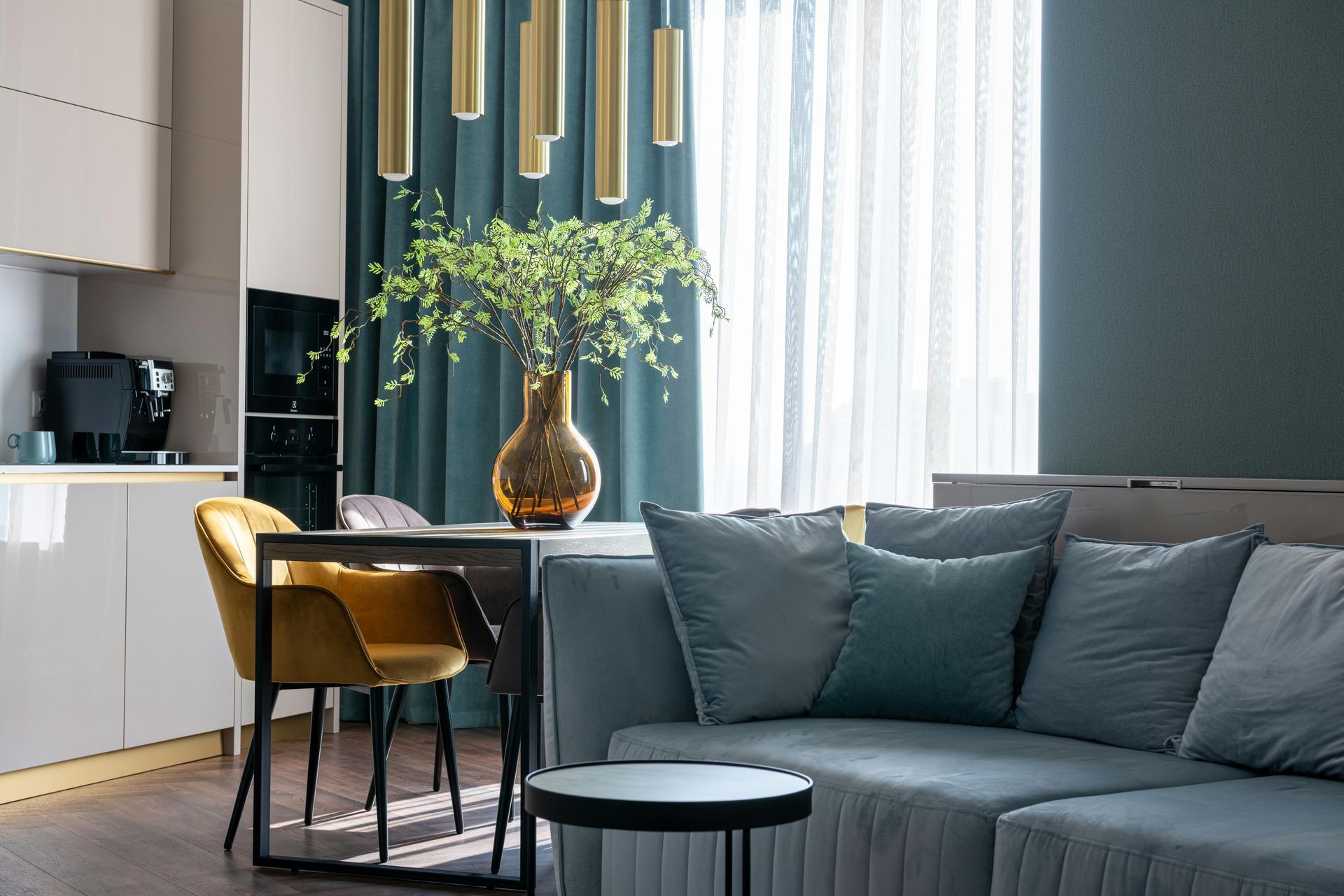 living space with a couch and table in front of a kitchen