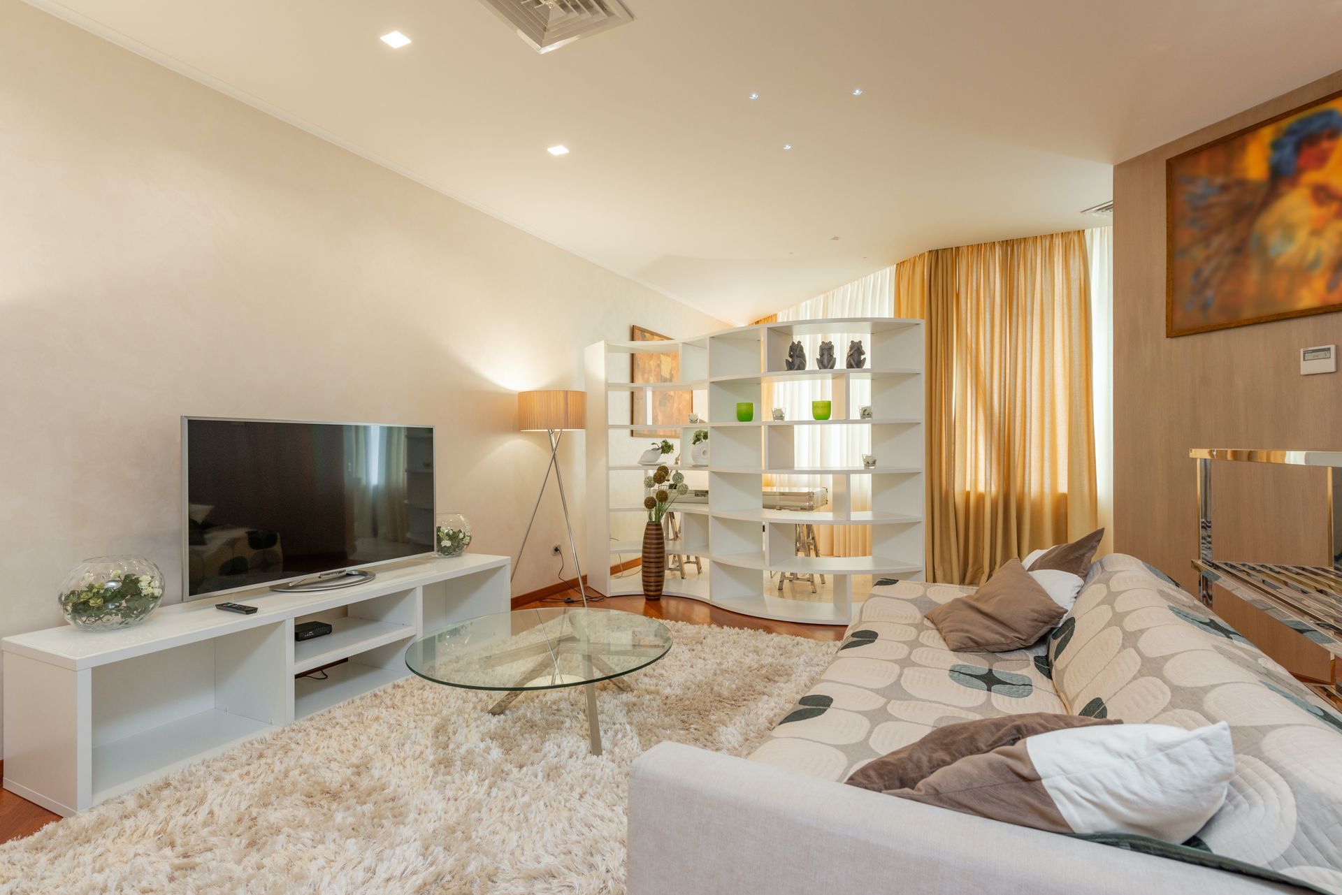 living room with couch and tv and a section blocked off with a bookcase