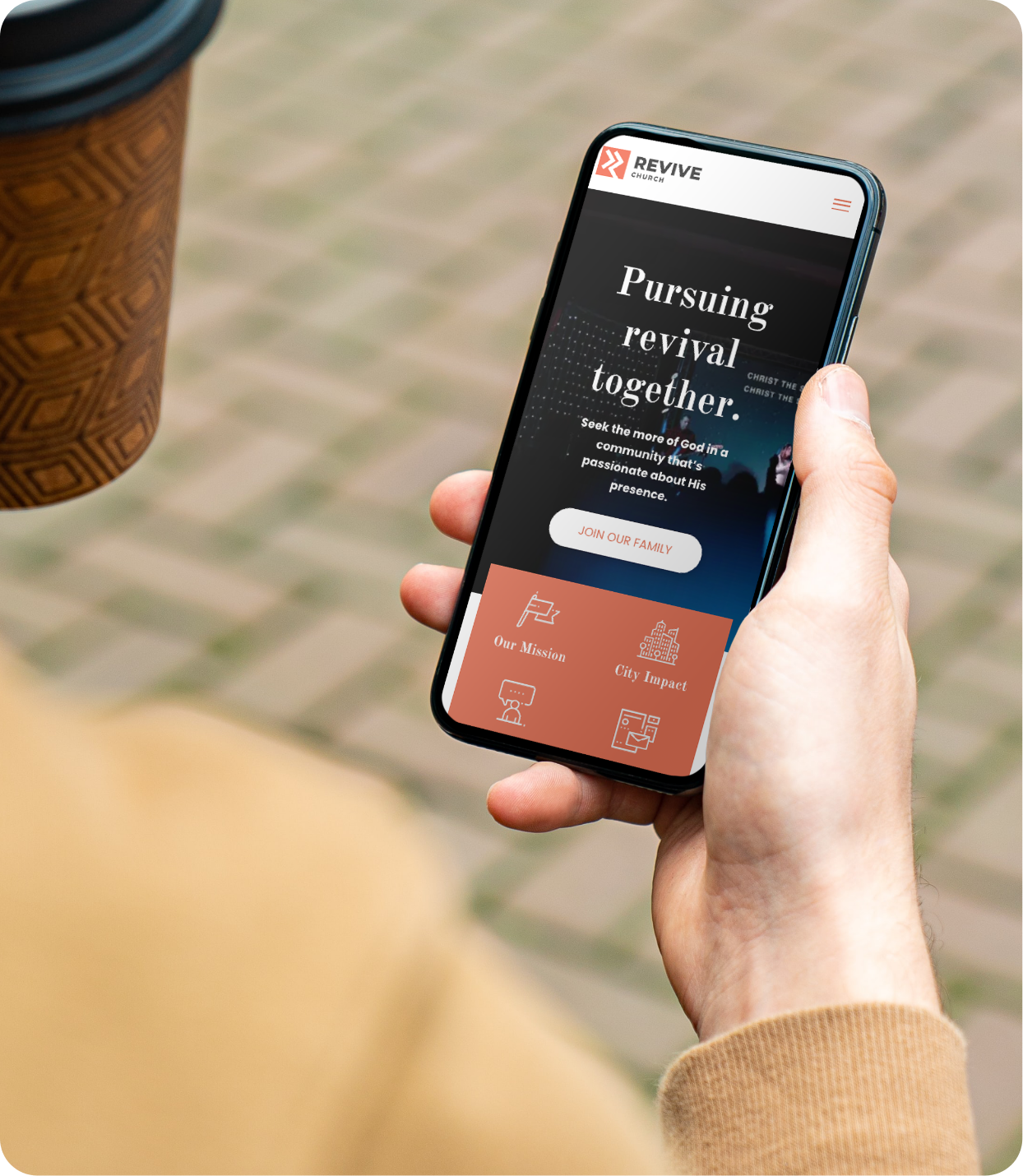Revive Church website template displayed on mobile as man holds cellphone