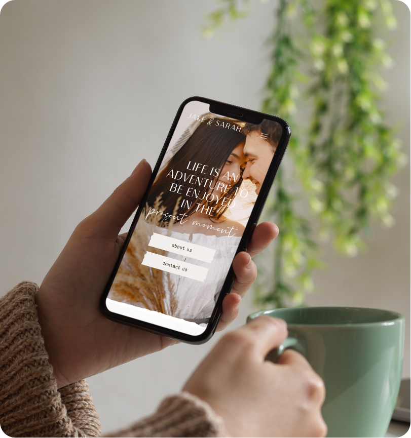 Home By Design’s website template displayed on mobile as man holds cellphone