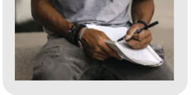 man with paper and pen writing