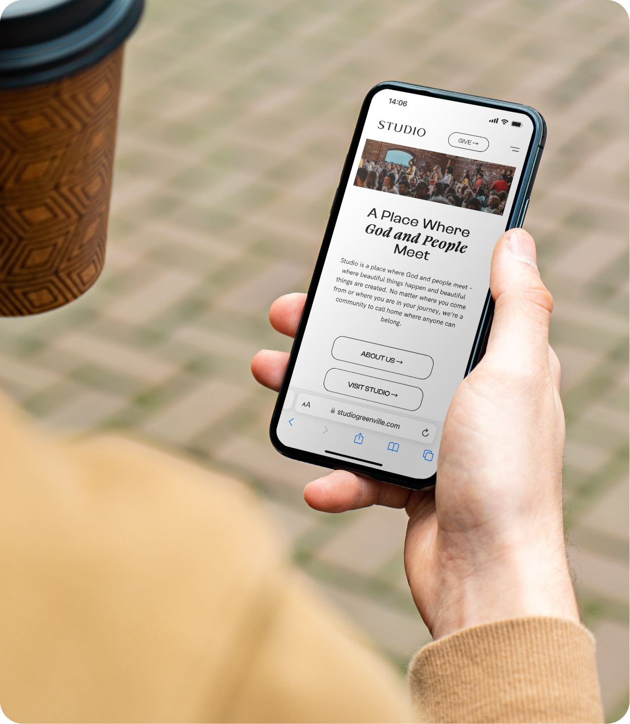 Studio Church website displayed on mobile as man hold cellphone