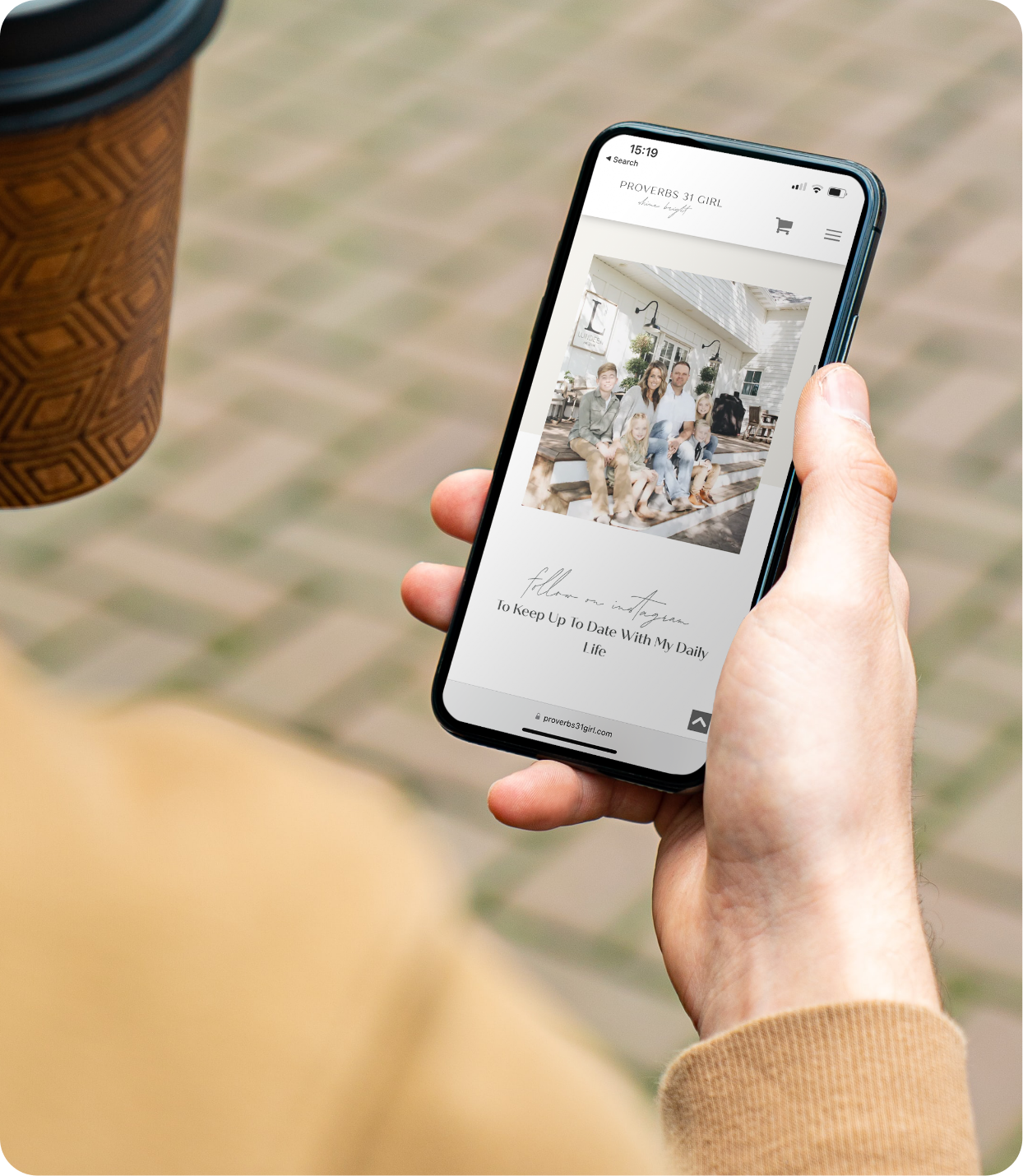 A New Paige website template displayed on mobile as man holds cellphone