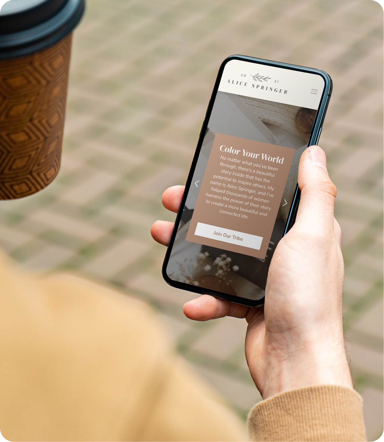 Alice Springer website template displayed on mobile in someone's hand