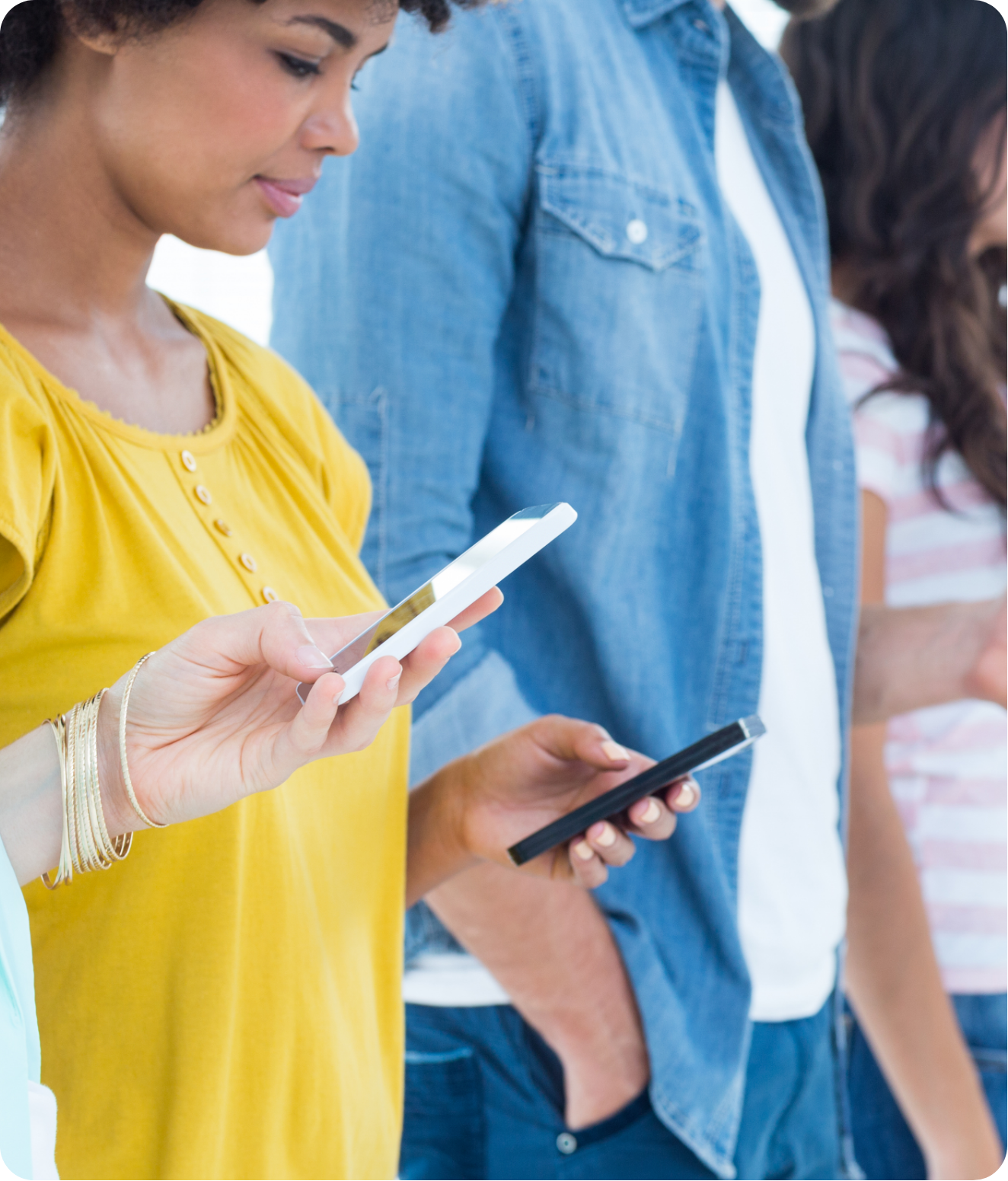 women standing together and looking at their phones