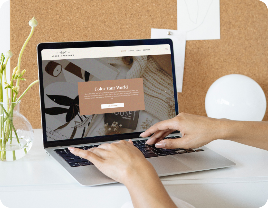 Alice Springer website template displayed on woman's laptop