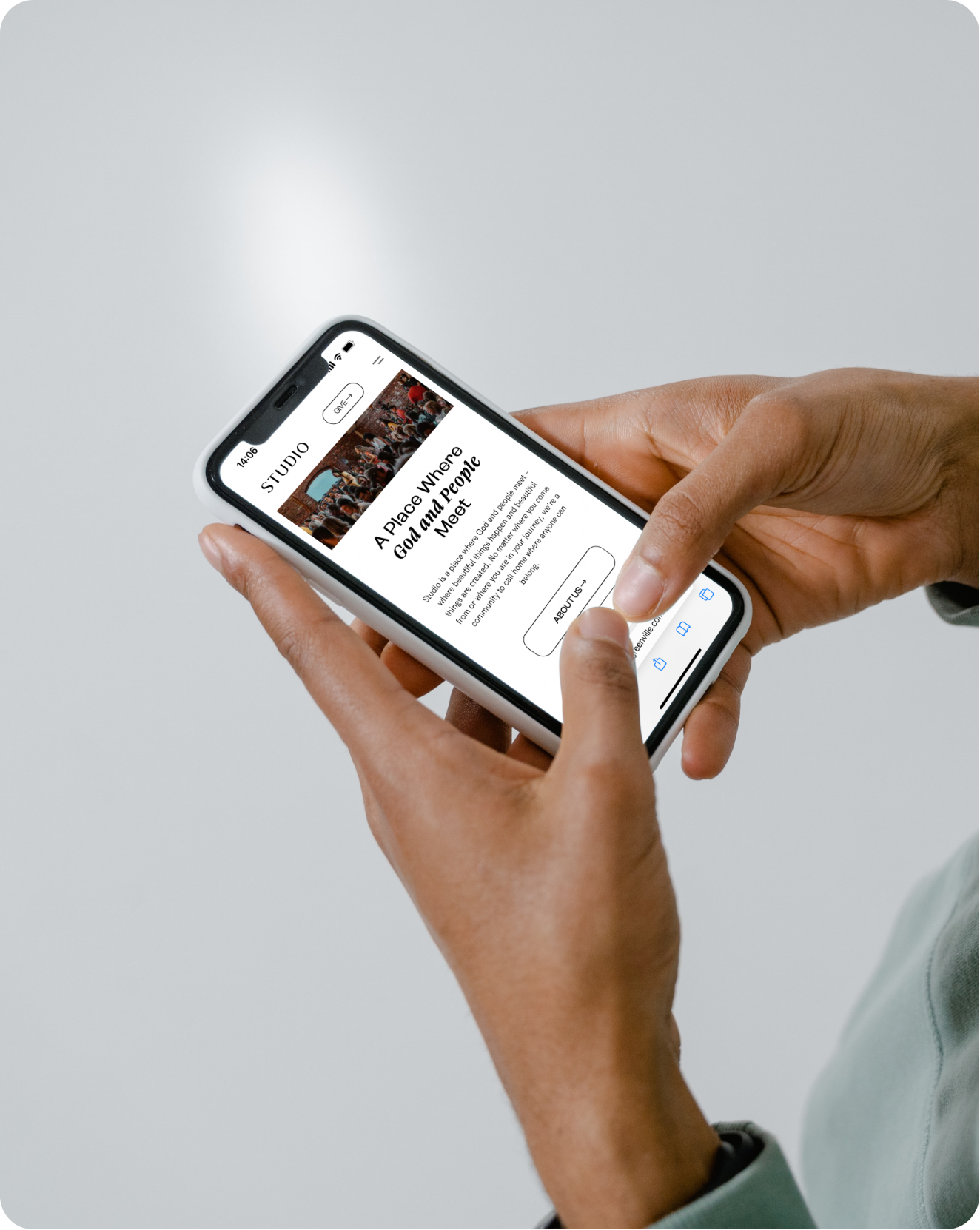 Studio Church's website homepage displayed on a cellphone someone is holding