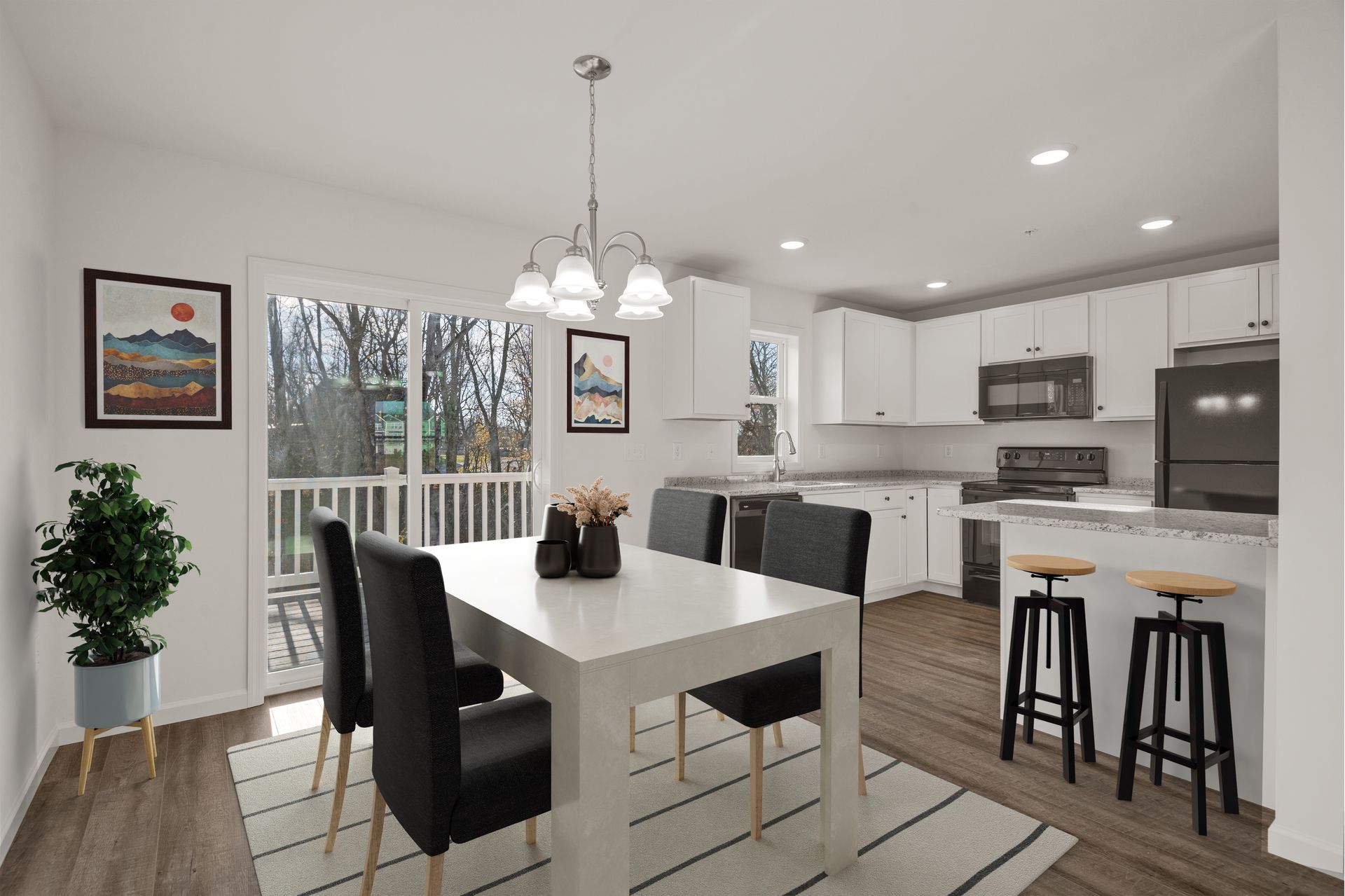 A dining room with a table and chairs and a kitchen.