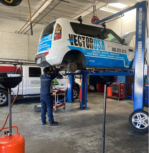 White and Blue car in garage | Torrance Tires & Auto Care