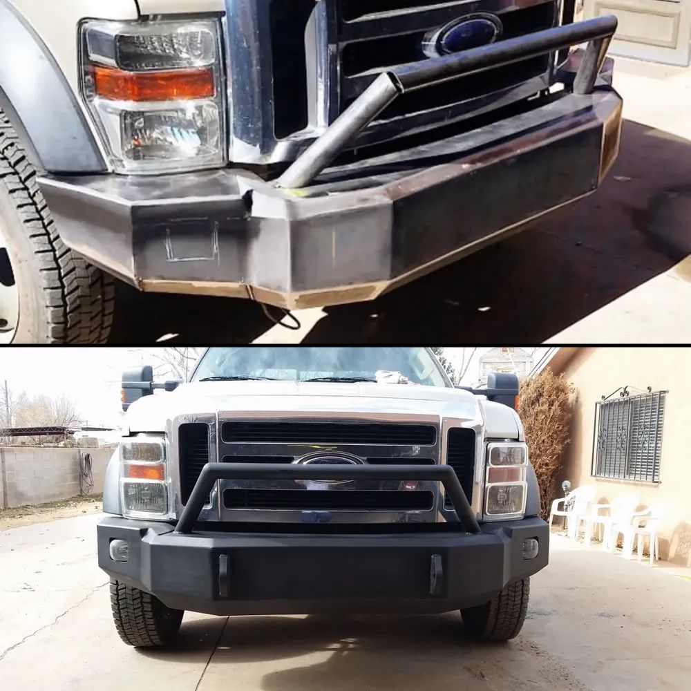 Front view of a black truck with a heavy-duty grille guard and bumper, shown in a driveway.