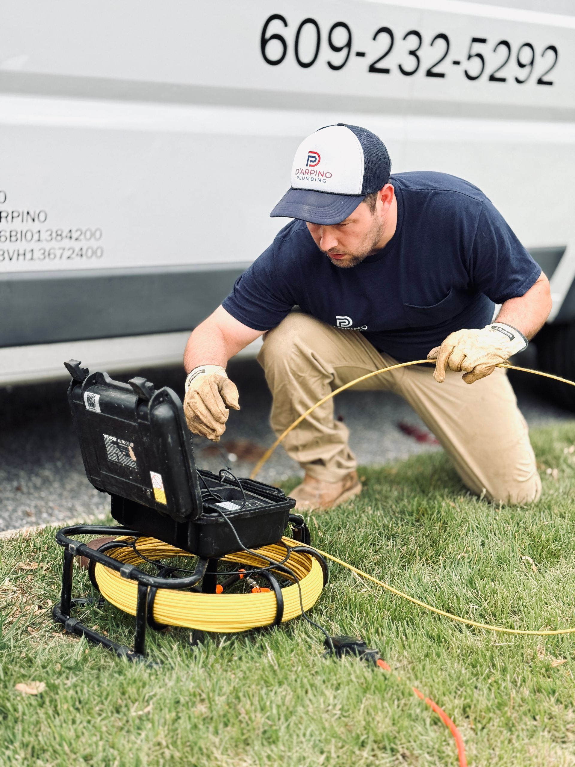 Plumber working in front of truck