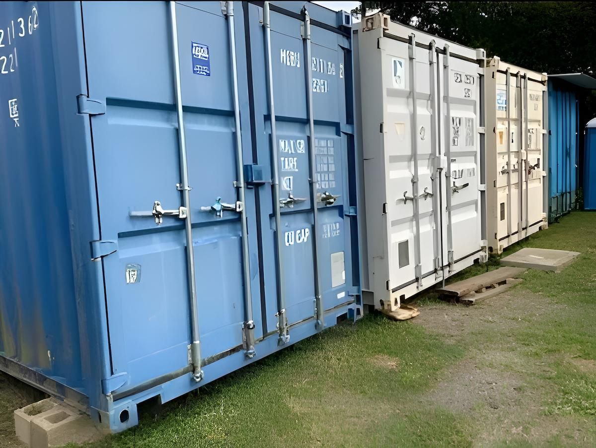 Pile Of Cardboard Boxes In Front Of A Warehouse Storage Shelving Unit — Cairns Budget Storage In Mount Sheridan, QLD