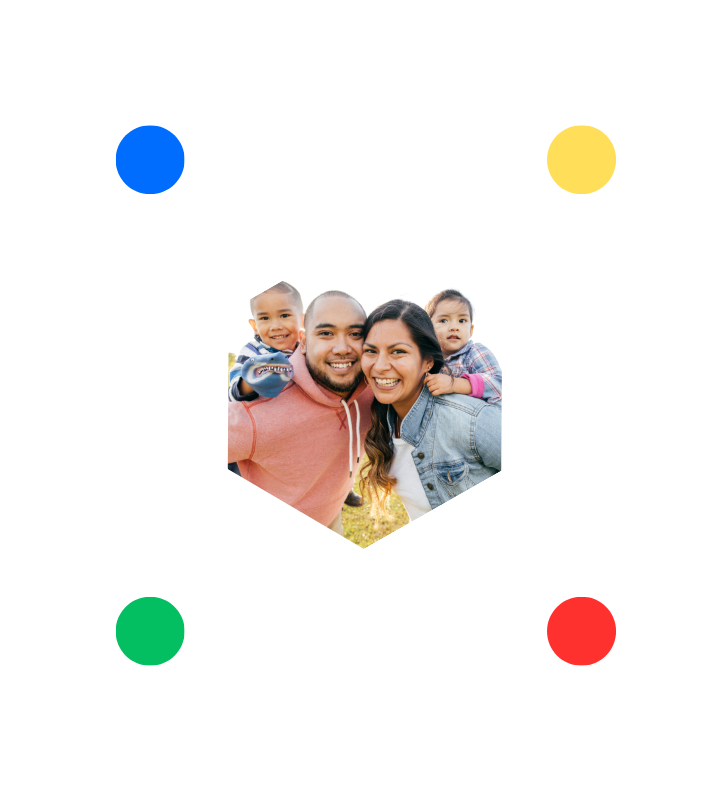 A family is posing for a picture in a hexagon with colorful circles around them.