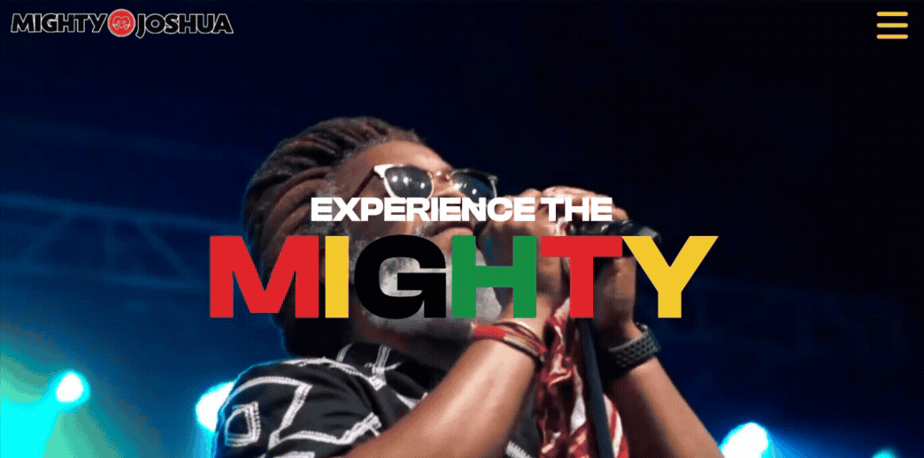 Concert singer on stage with “EXPERIENCE THE MIGHTY” text and a hamburger menu in the corner