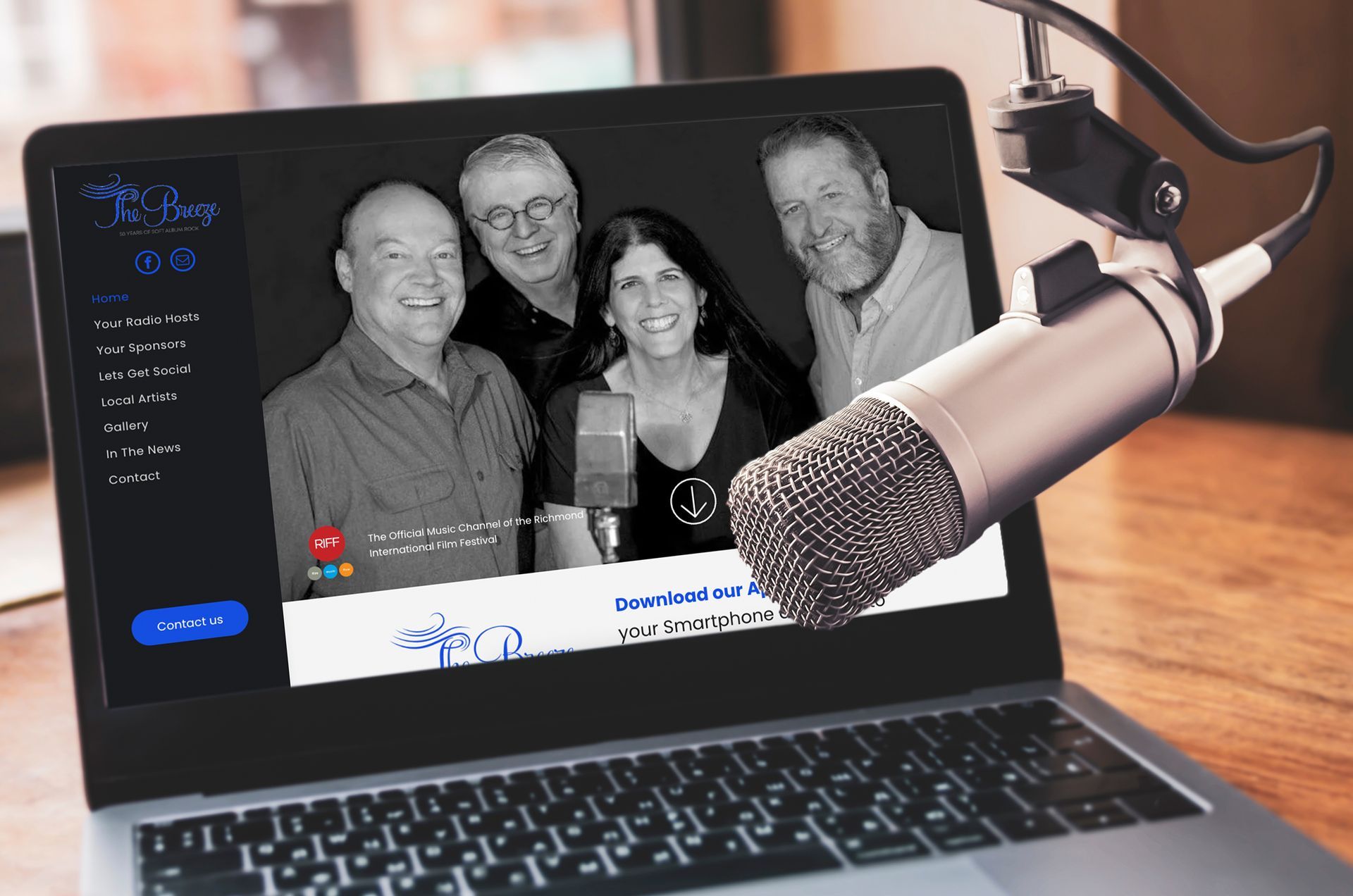 a group of people are standing in front of a microphone on a laptop