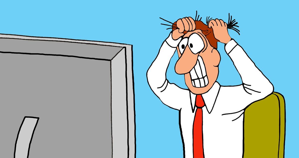 Stressed man in white shirt and red tie gripping his hair while staring at a computer monitor