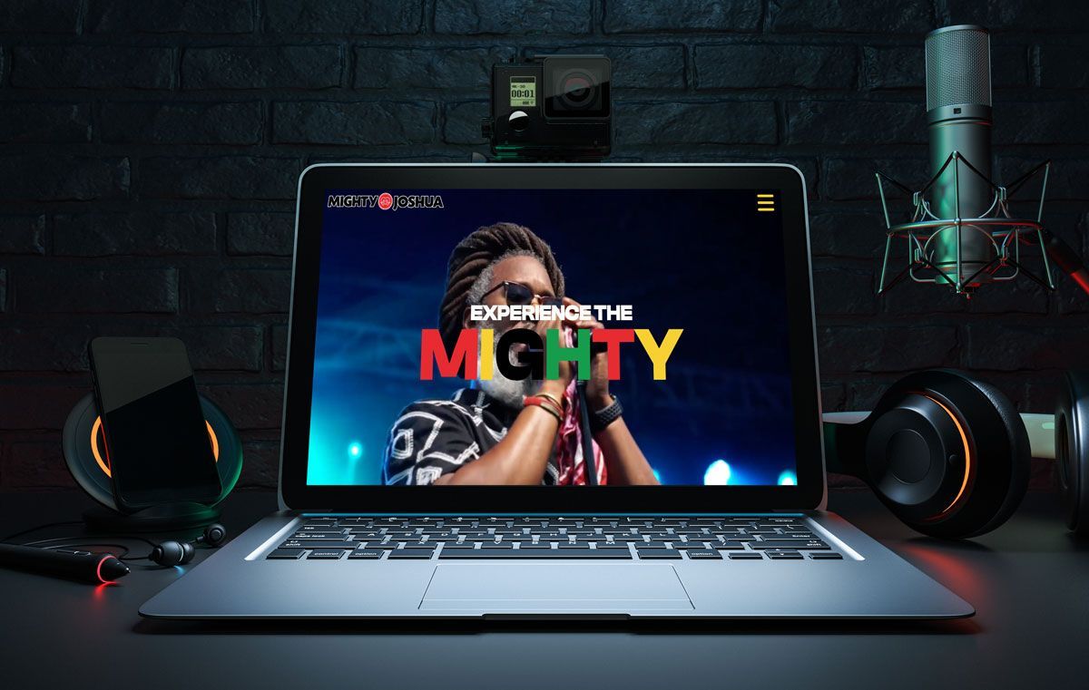 Laptop displaying a singer performing on a stage. Text reads