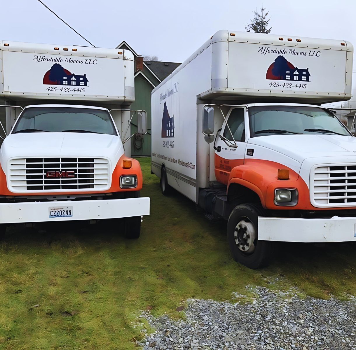 Two white and orange moving trucks parked on grass, both with Affordable Movers logos.