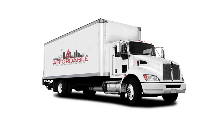 Movers in red shirts loading a truck. The shirts have the logo