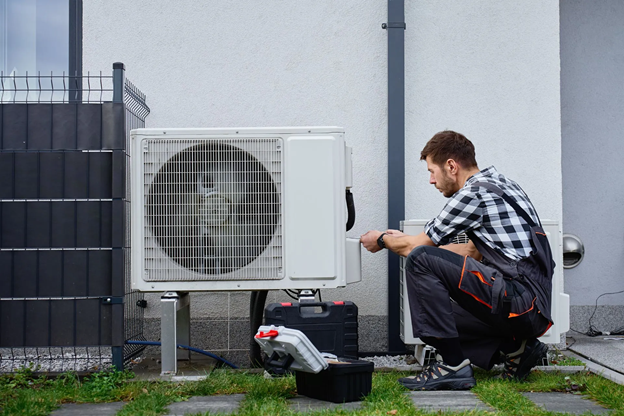 HVAC technician providing heating services and inspecting a residential furnace in Omaha, NE. 