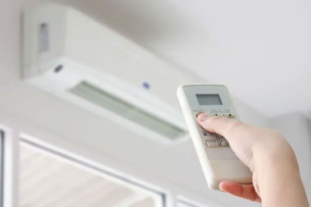 Air conditioning repair service in Kennard, NE by an Andy’s Cooling and Heating technician inspecting a residential AC system. 
