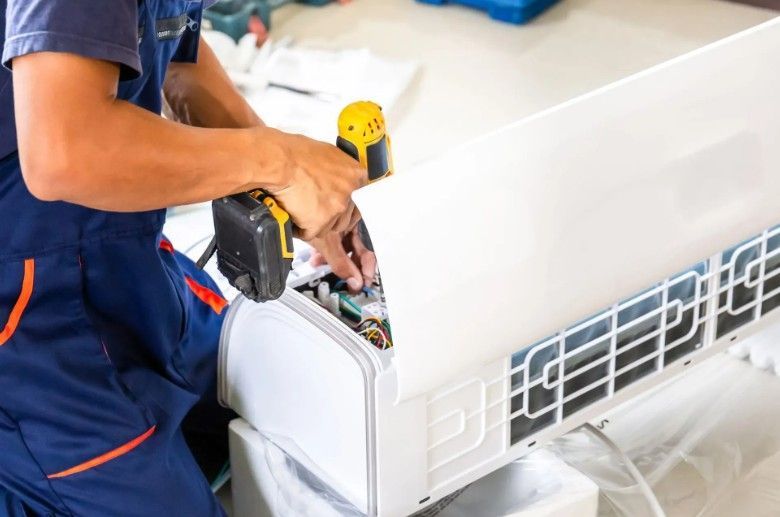 HVAC technician performing air conditioning replacement for an Omaha home. 