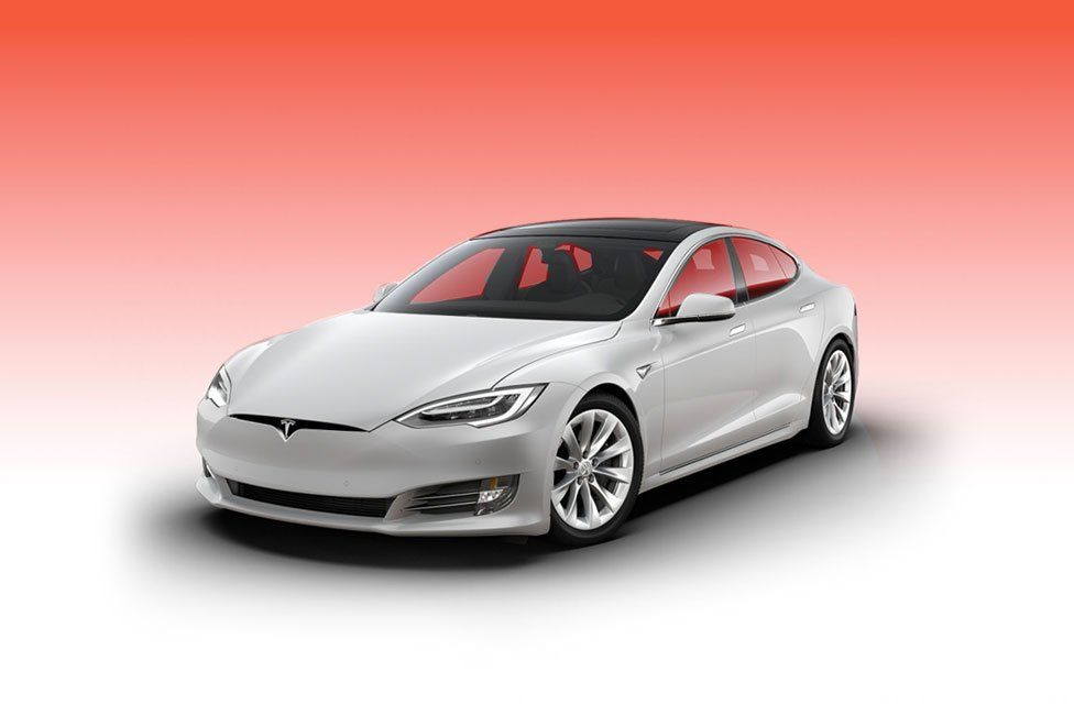 White Tesla Model S car with a black roof against a gradient red background.