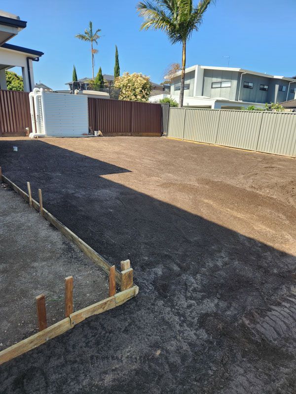 A driveway is being built in front of a house