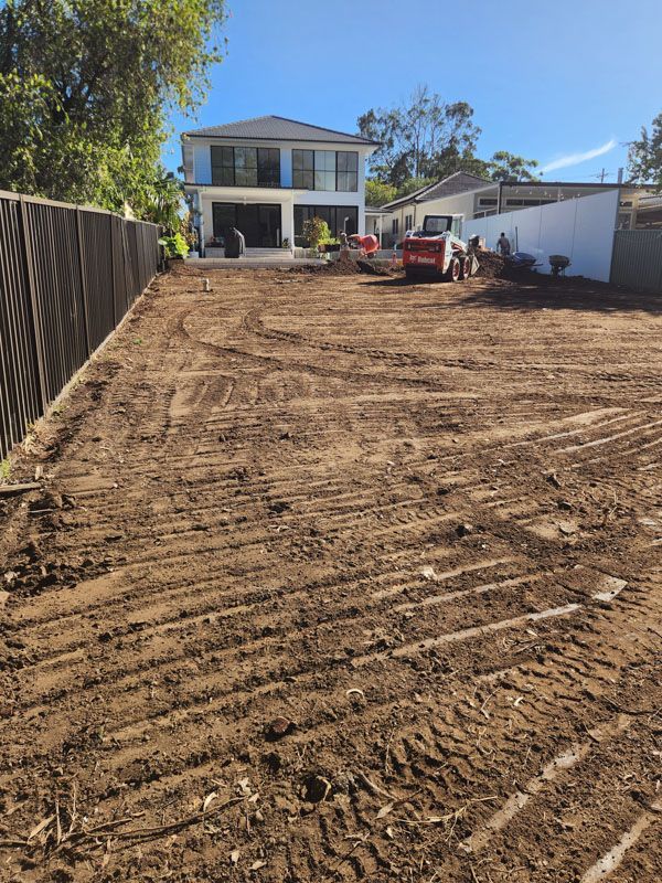 A large house with a lot of dirt in front of it.