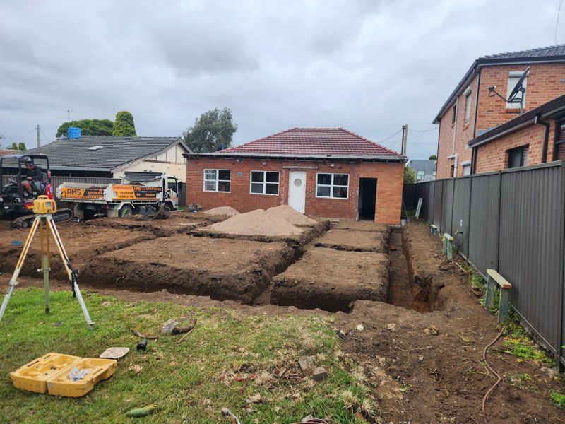 A house is being built in the backyard of a house.