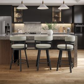Modern kitchen with dark cabinets, stone island, three stools, and pendant lights over wood floors Modern kitchen with dark cabinets, stone island, three stools, and pendant lights over wood floors