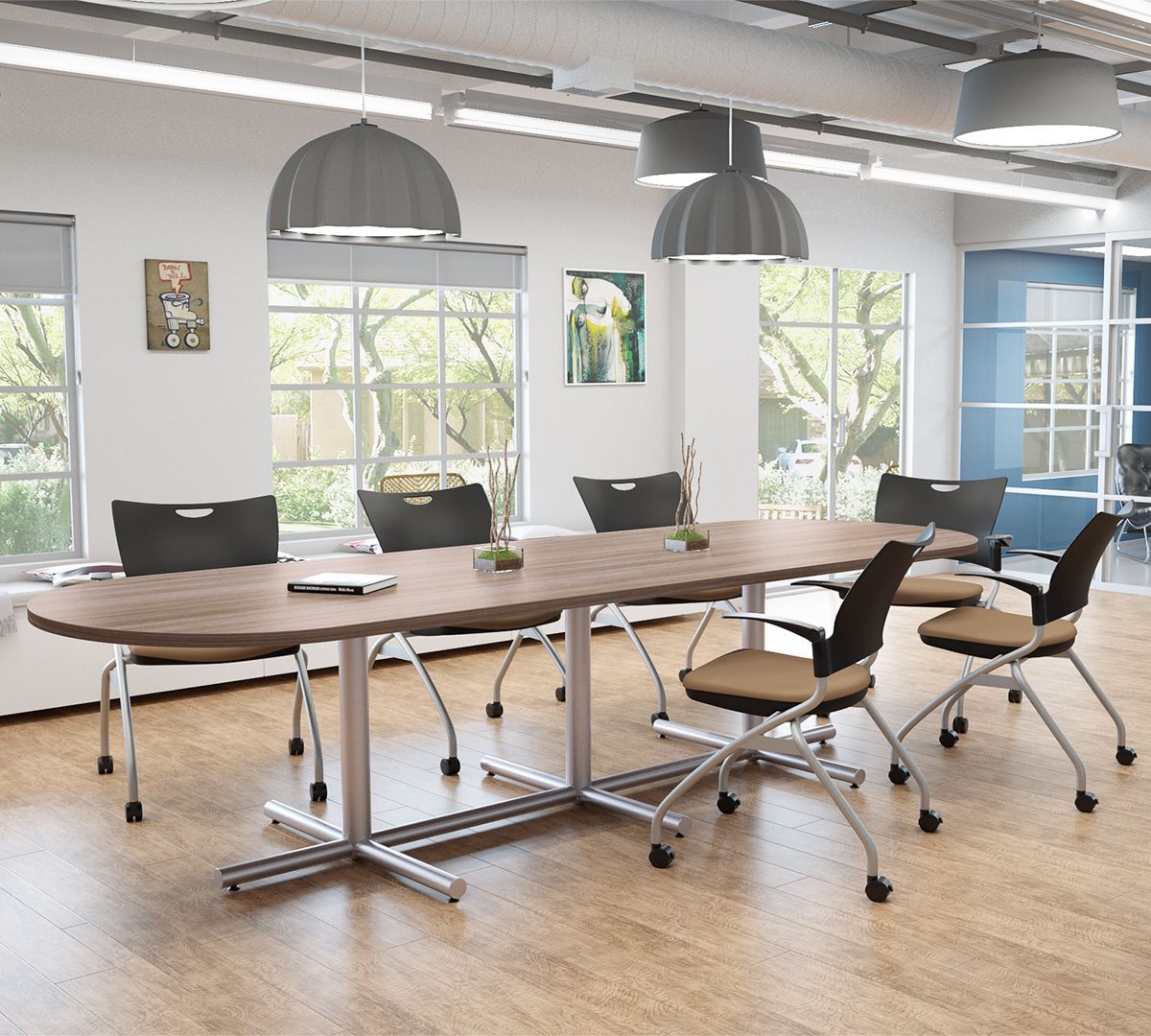Oval conference table with chairs in a bright office.