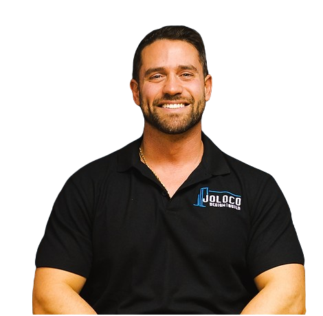 A man wearing a black polo shirt with the word nology on it
