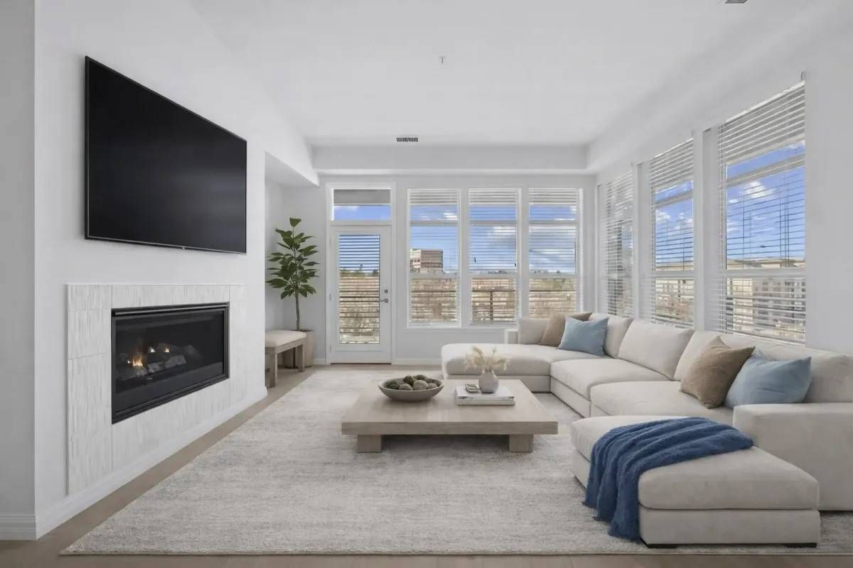 Living room with a fireplace, large sectional sofa, and a coffee table.