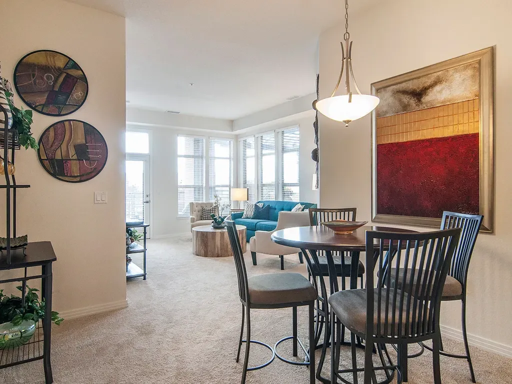 Dining area and living room with furniture and decor.