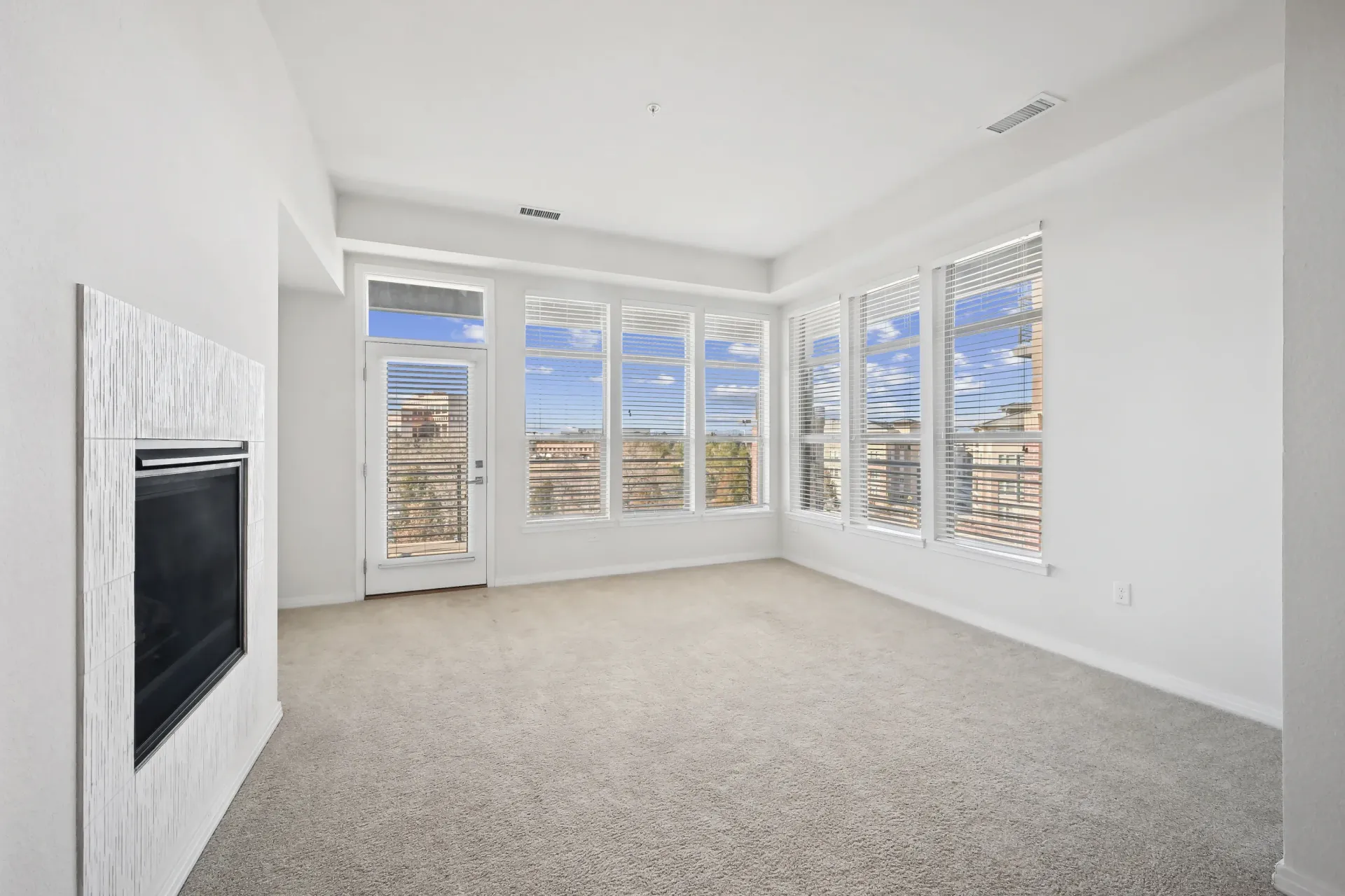 Spacious living room with a modern fireplace and large windows.