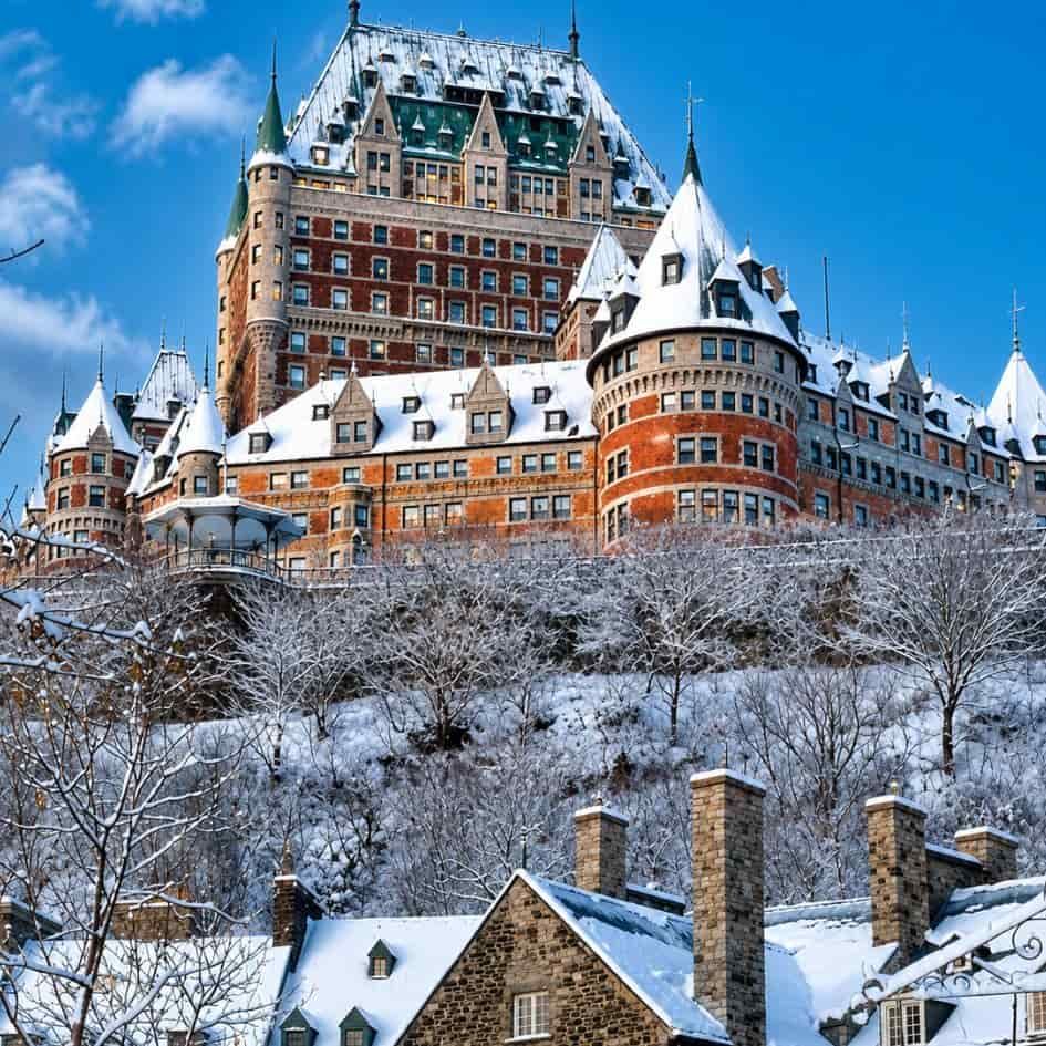 Château Frontenac in Québec City during winter, blanketed in snow above the historic Old Québec district, showcasing the magical atmosphere of a Canadian Christmas getaway.