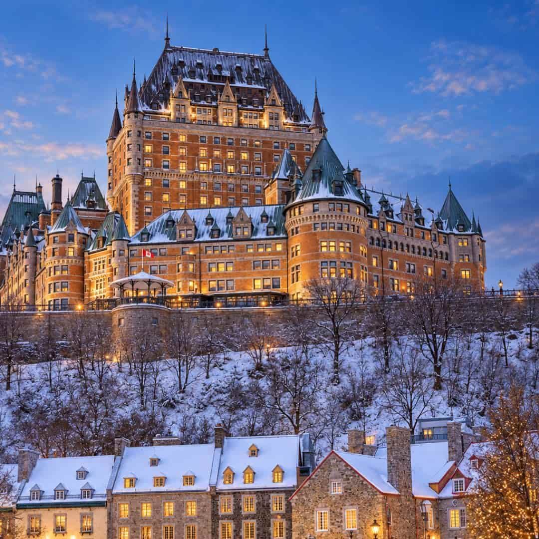 Fairmont Le Château Frontenac illuminated on a snowy winter evening in Québec City