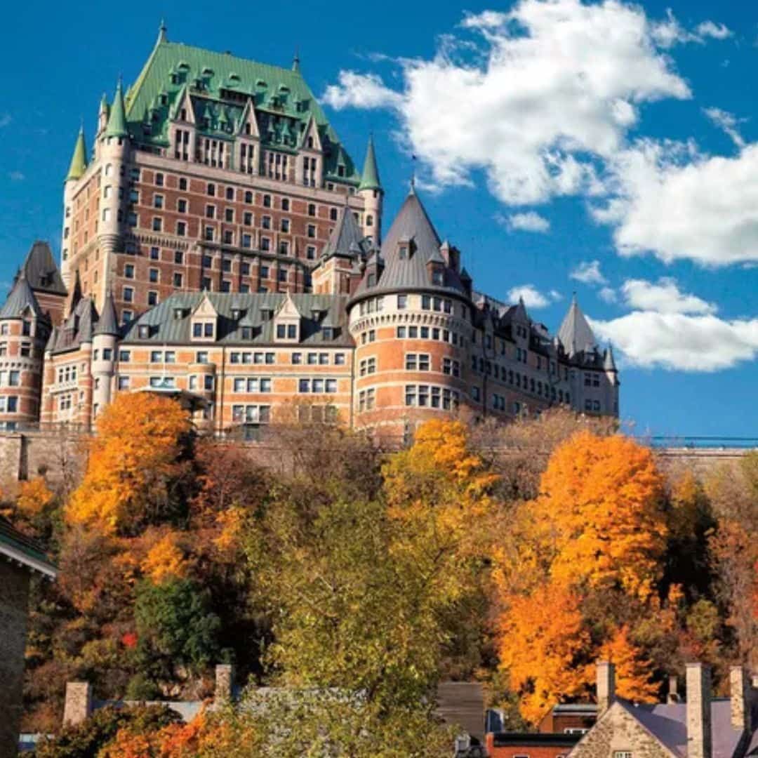 Château Frontenac surrounded by colourful autumn foliage in historic Québec City