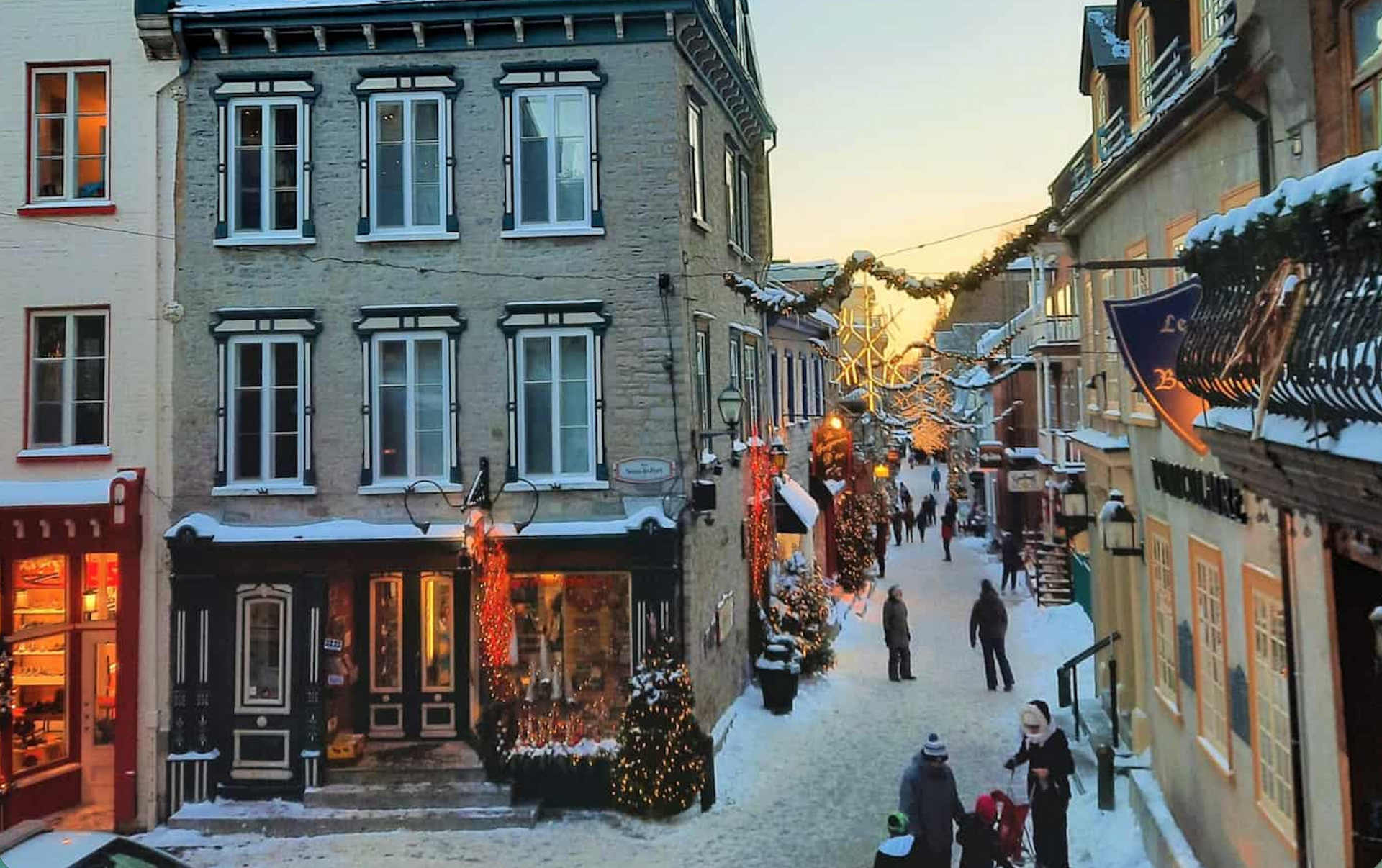 Snow-covered street in Old Québec decorated with Christmas lights