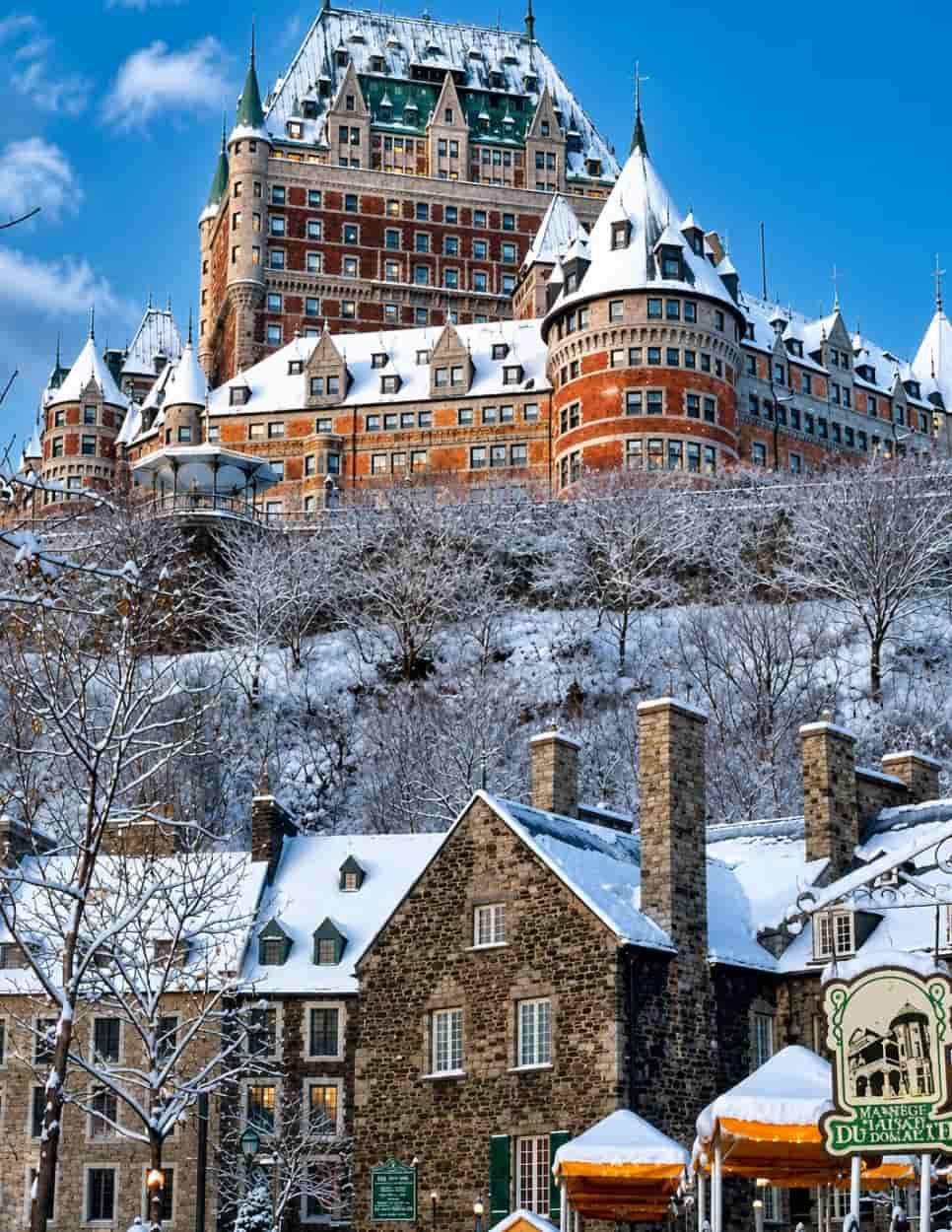 Château Frontenac in Québec City during winter, blanketed in snow above the historic Old Québec district, showcasing the magical atmosphere of a Canadian Christmas getaway.