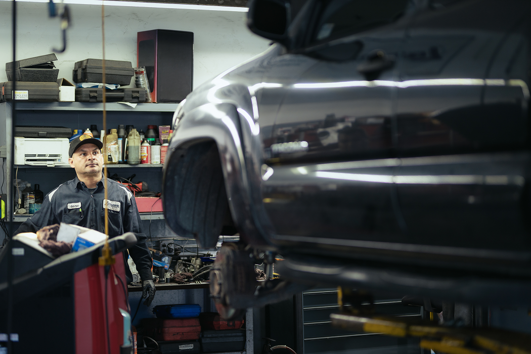 A man is working on a car in a garage | Larsen Automotive