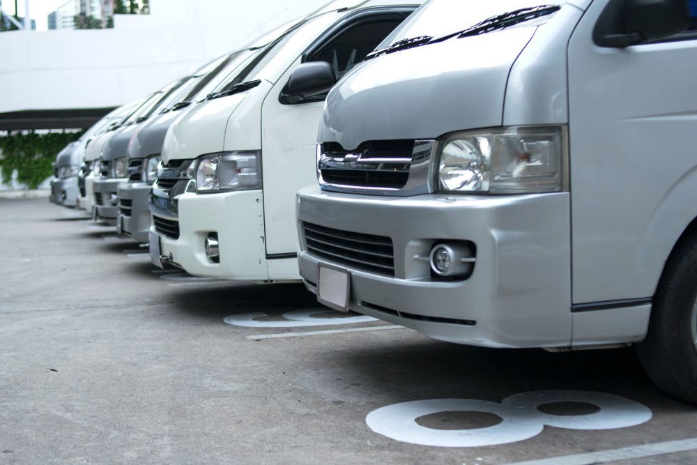 A Row of Vans Are Parked in a Parking Lot — Automotive Repair Centre In Garbutt, QLD