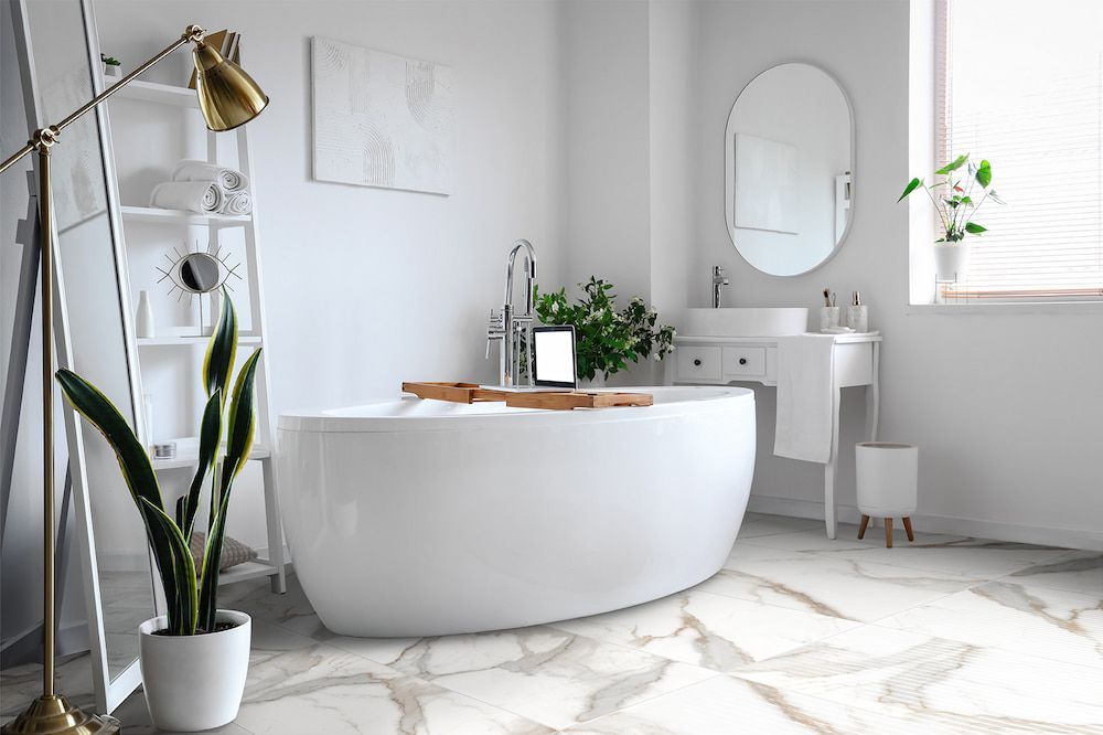 A Bathroom With a Bathtub, Sink, Mirror and Plant — Tileflair in Mitchell, ACT