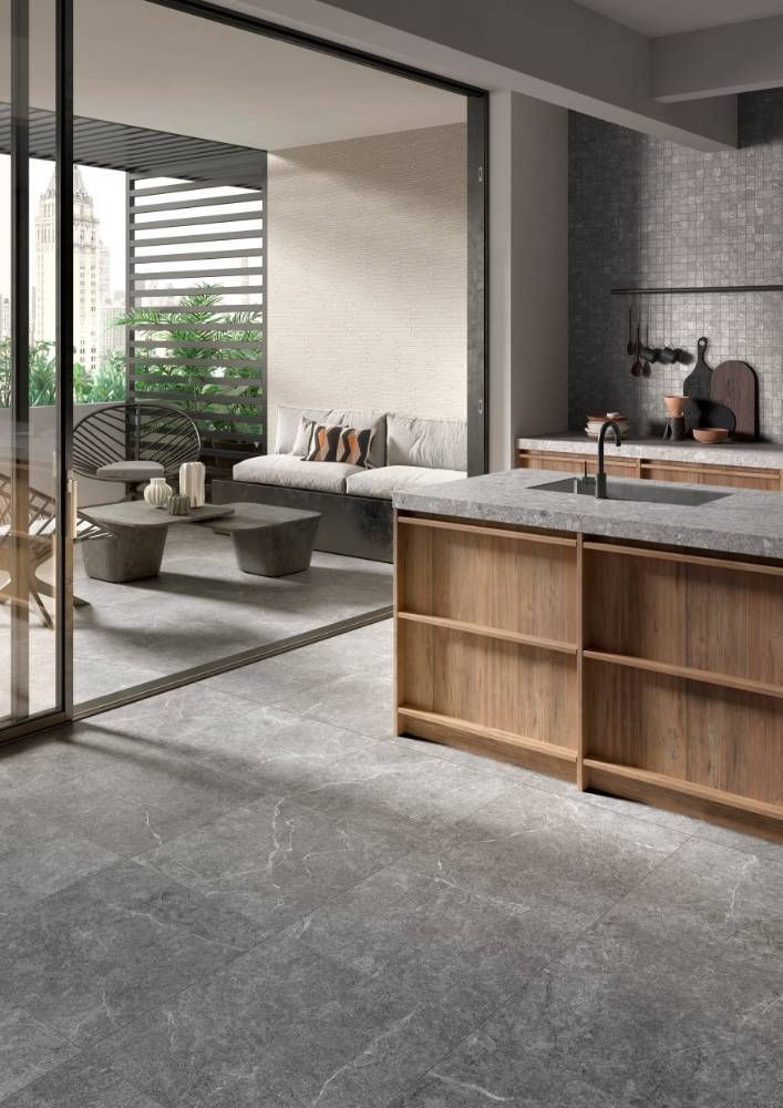 A Kitchen With a Wooden Island and a Sliding Glass Door Leading to a Patio — Tileflair in Mitchell, ACT
