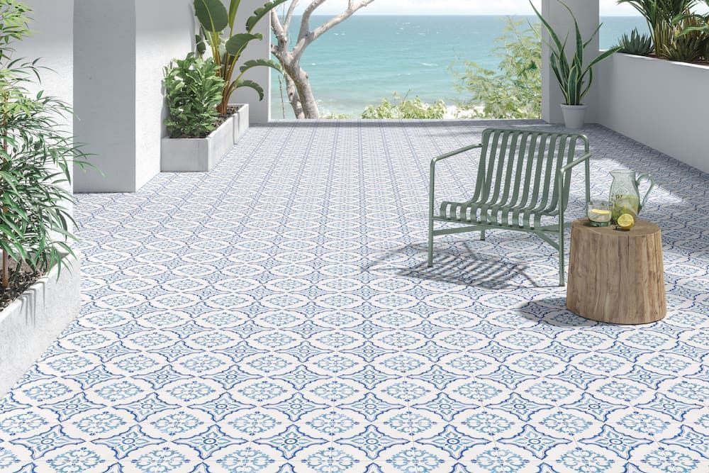 A patio with a chair and a table with a view of the ocean — Tileflair in Mitchell, ACT