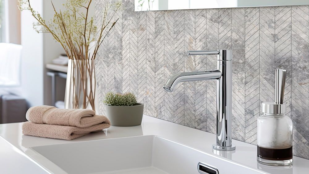 A Bathroom Sink With a Soap Dispenser and Towels on the Counter — Tileflair in Mitchell, ACT