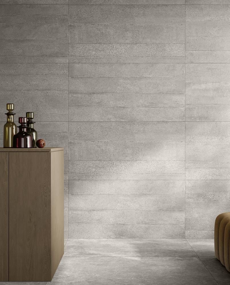 A Room With a Gray Wall and a Wooden Table With Bottles on It — Tileflair in Mitchell, ACT
